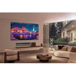 LG OLED77G6 TV OLED 77 pouces fixé au mur, salon contemporain avec écran affichant paysage nordique enneigé